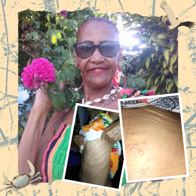 Elba dos Santos é uma mulher preta não retinta, que usa cabelo preso, óculos escuros, brincos grande e segura um galho verde com uma flor rosa