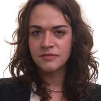 Mulher trans branca, de cabelos castanhos avermelhados na altura dos ombros