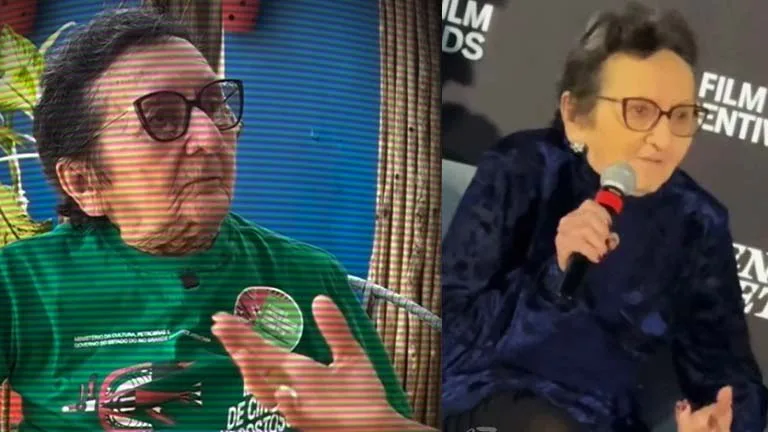 Imagem dividida em duas partes com a artista Tânia Maria. À esquerda, ela aparece em um ambiente interno, usando óculos escuros e camiseta verde, gesticulando enquanto fala. À direita, Tânia Maria veste roupa escura e segura um microfone durante um evento público, com um painel ao fundo.